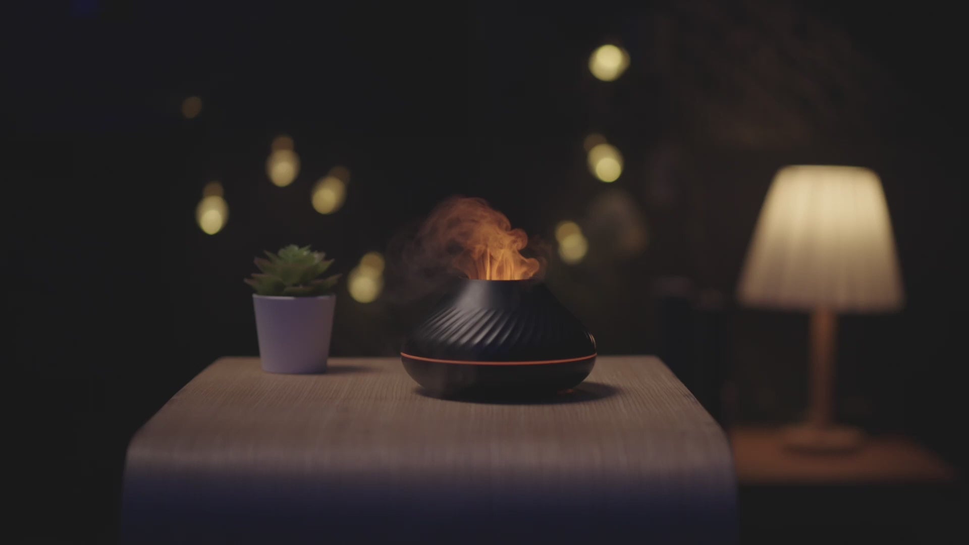 The LavaLux™ Diffuser, in black, with a spectacular golden "flame" effect, in action. In the video, the diffuser is showcased on a bookshelf, on a desk, and on a shelf, with demonstrations of adding water and essential oils. Discover the relaxing atmosphere created by the fine mist and the 7 LED colors, including the golden and blue "flame" effects, for a unique aromatherapy experience.